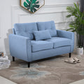 Blue tufted 2 seater fabric loveseat sofa in a modern living room