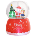 Inflated snow globe with Santa, a reindeer and a tree above a red Merry Christmas base