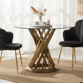 Black glass round dining table with gold hourglass base styled in a dining room setting