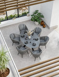 Aspen 6 seater oval ceramic glass garden dining set seen from above, grey top with six rope chairs