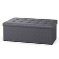 Slate grey folding storage ottoman bench, lifestyle shot in living room