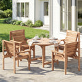 Wooden outdoor dining set with table and chairs on a patio in front of a house.