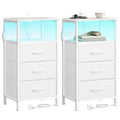 Two Cloud White Songmics bedside tables side by side, each with a lit open shelf and 3 fabric drawers, on a plain background