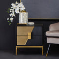 Black and gold 2 drawer side table with gold handles styled in a modern bedroom