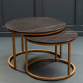 Black marble and gold nesting coffee tables styled in a modern living room beside a sofa