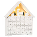 White wooden house advent calendar with 24 drawers and a lit village scene on a white background