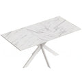 White marble effect extendable dining table with white steel cross legs on a plain background