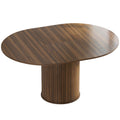 Dark walnut extendable round dining table opened to an oval shape on a white background