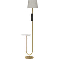 Gold floor lamp with linen shade and round white shelf on a white background