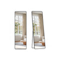 Two views of the black full-length mirror, one flat for wall mounting and one leaning on its fold-out stand