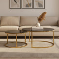 Gold and glass round nesting coffee tables styled in a living room