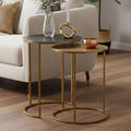 Gold and zinc metal nest of 2 side tables styled beside a sofa in a living room