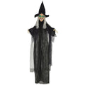 Hanging Halloween witch decoration in a black robe with green light-up eyes on a white background