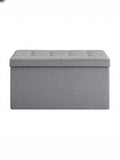 Light grey tufted fabric storage ottoman bench, studio shot