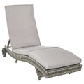 Image of an ergonomic curved rattan sun lounger with cushion and wheels