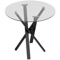 Round clear glass dining table on black criss-cross steel legs, white background