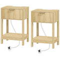 Pair of oak fluted bedside tables with drawers and open shelves, power cables trailing from each