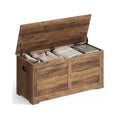 Honey brown Vasagle shoe storage bench with lift-top lid open, packed with a blanket and books