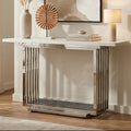 White marble effect console table with silver geometric steel base in a styled room setting
