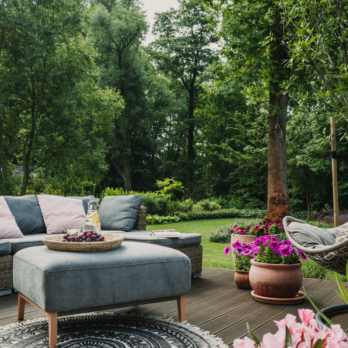 A Cosy Garden Scene With Patio furniture Set With Rattan Sofa, Footstool and Helicopter Swing Chair