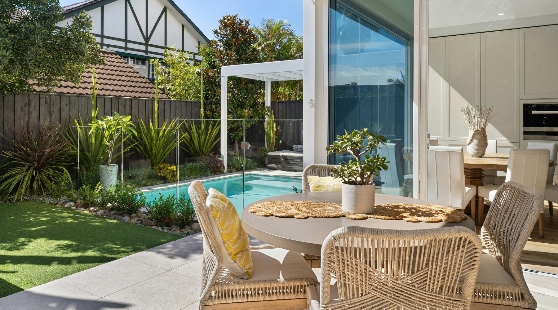 A modern garden with a patio and wicker patio dining set