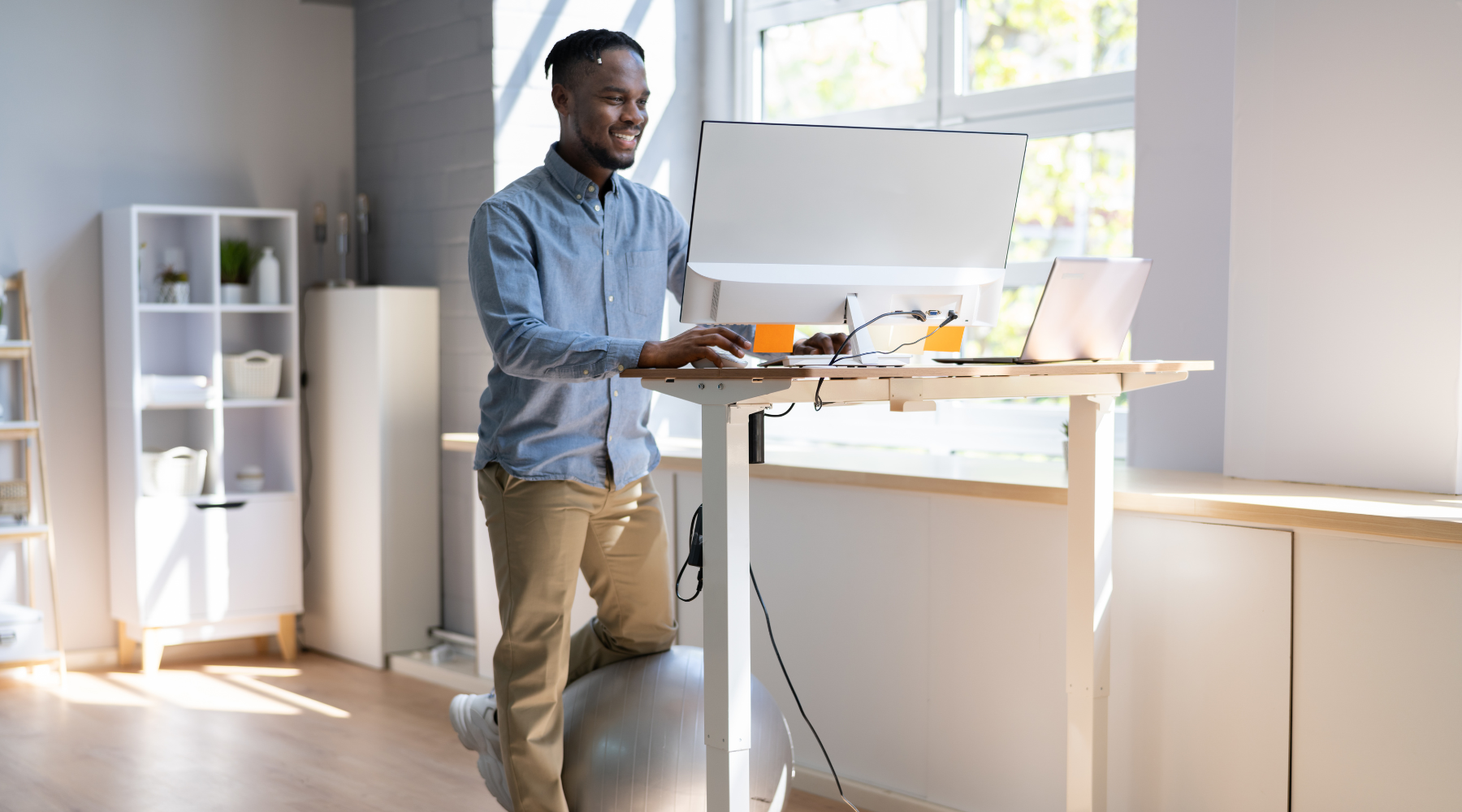 Image of a remote worker using an electric standing desk