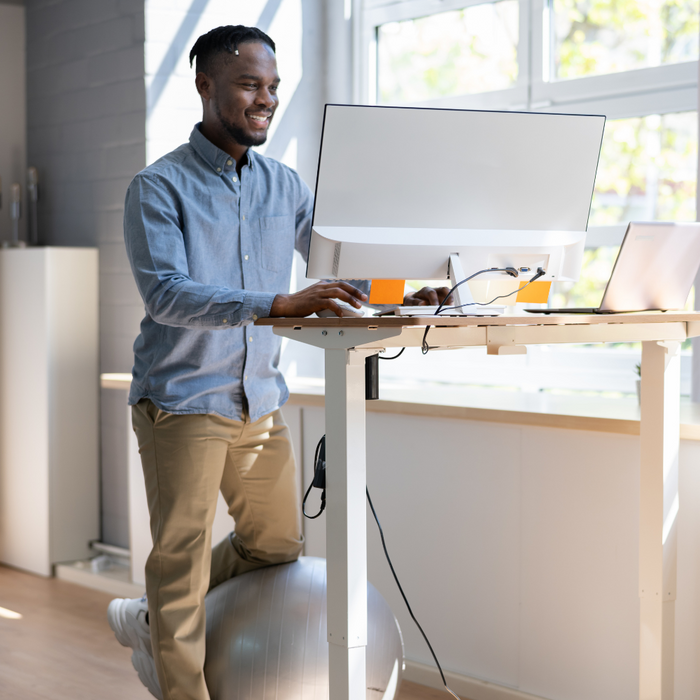 Image of a remote worker using an electric standing desk