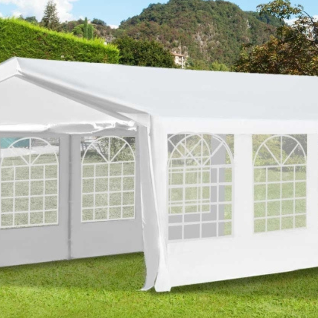 Large white party tent marquee set up in a UK garden for an outdoor event