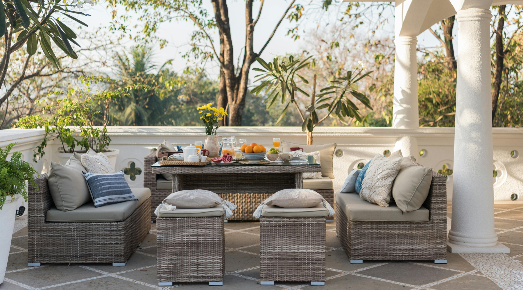 Modern designed terrace with rattan patio dining furniture and plants