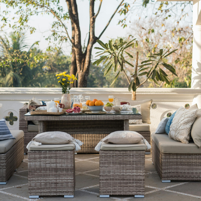 Modern designed terrace with rattan patio dining furniture and plants