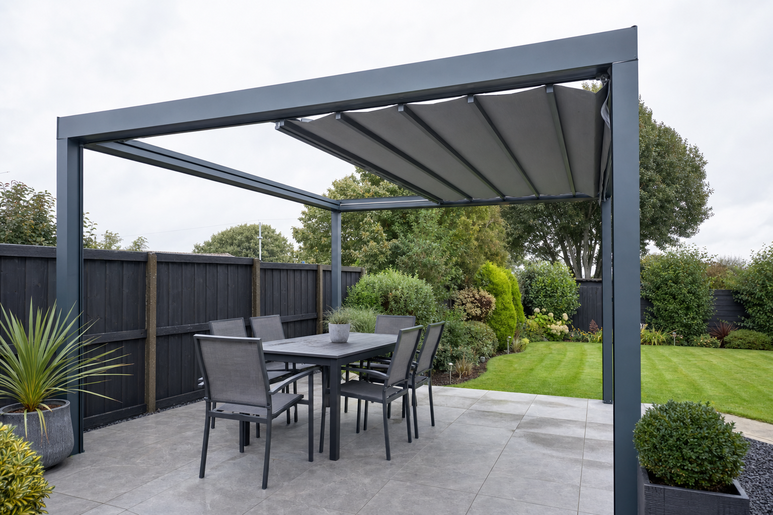 Aluminium pergola with retractable canopy roof on a patio in a UK garden