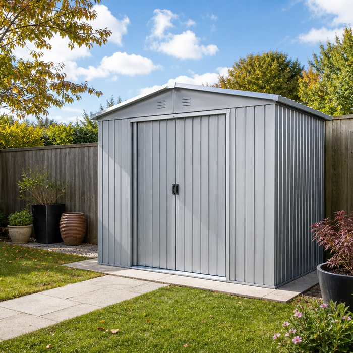 Modern grey metal garden shed with apex roof in a tidy UK back garden on a bright day