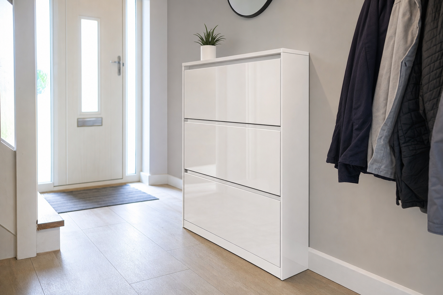 Slim white shoe cabinet with flip drawers in a modern UK hallway with coat hooks and tiled floor