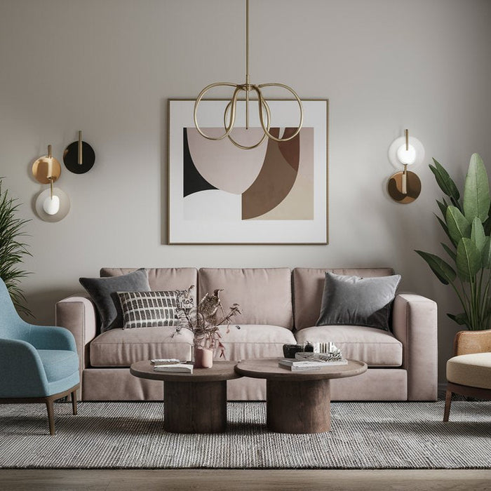 Living room styled with a pink sofa, blue and cream accent chairs, and layered round coffee tables