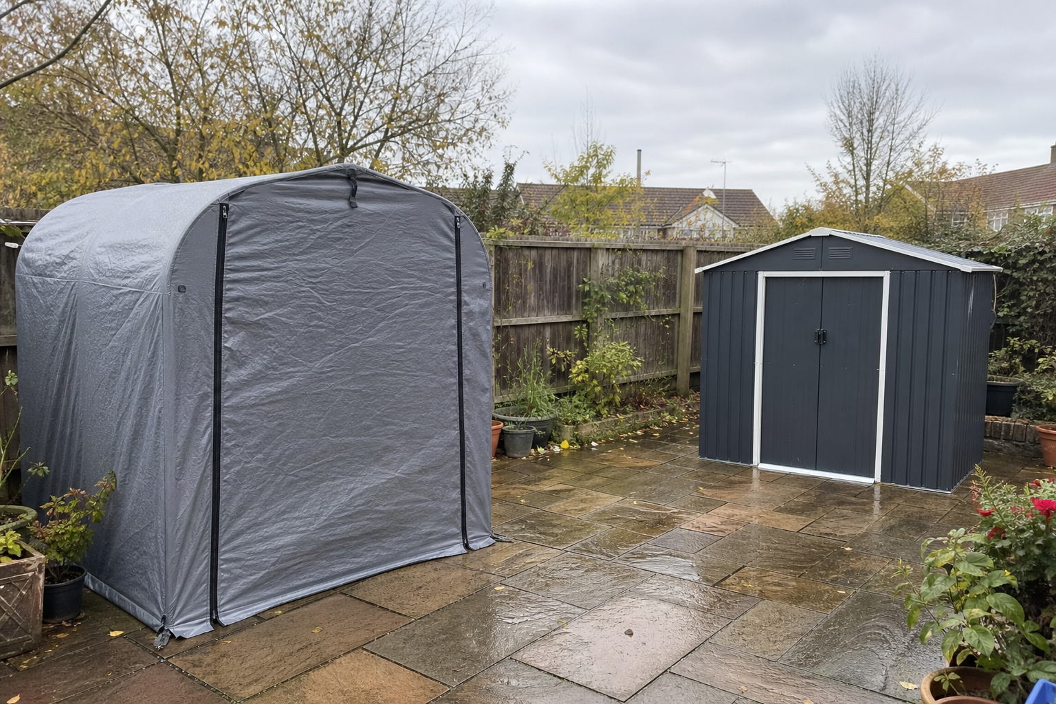 Grey fabric pop-up storage shed tent next to a small metal garden shed in a UK back garden