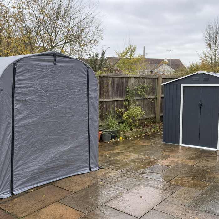Grey fabric pop-up storage shed tent next to a small metal garden shed in a UK back garden