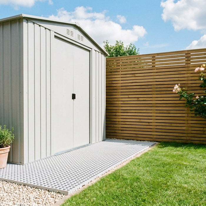 A garden shed installed on a plastic grid base in a bright UK back garden