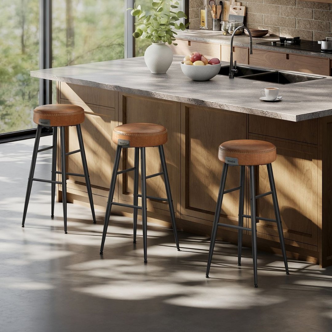 Image of a set of Vasagle brown leather bar stools without backs around a kitchen island