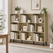 Oak 10-cube bookcase styled with books, plants and decor in a living room