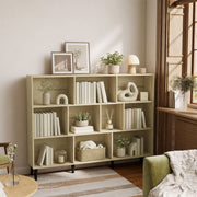 Oak 10-cube bookcase near a window with books and framed art on top