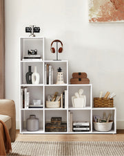 White bookcase in a living room styled with vases and books
