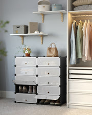 The modular shoe rack rebuilt as two shorter side by side blocks in a bedroom, holding shoes and linen
