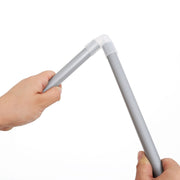 Hands pushing a metal pole into a plastic joint connector by hand