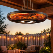 Heater hanging from a pergola beam glowing at sunset with string lights behind