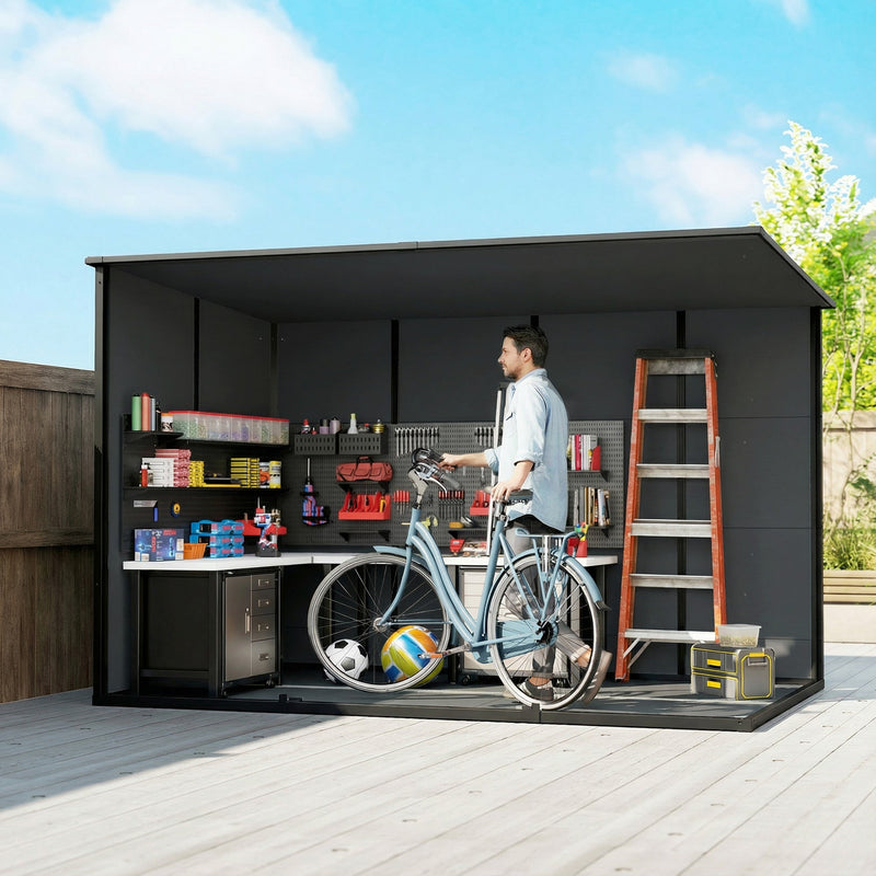 Cutaway view of the dark grey garden storage shed's interior with a workbench, shelving, ladder and bike