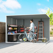 Cutaway view of the grey garden storage shed's interior with a workbench, shelving, ladder and bike