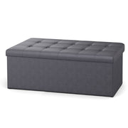 Slate grey folding storage ottoman bench, lifestyle shot in living room
