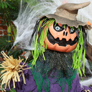 Close-up of the pumpkin scarecrow's jack-o'-lantern face and straw arms