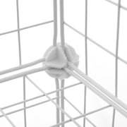 Close-up of a white plastic corner connector joining the wire mesh panels