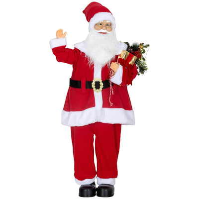 Standing Santa Claus figure holding a foliage-trimmed gift bag on a white background